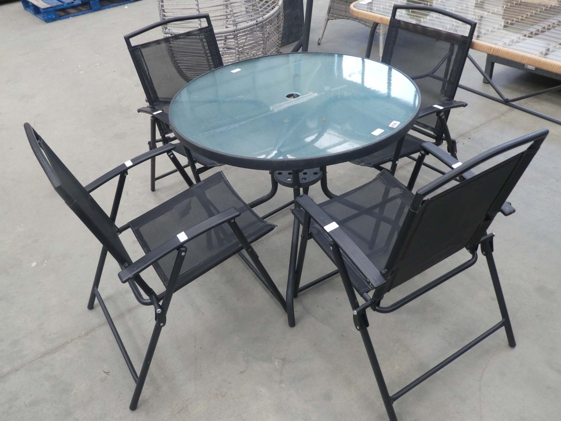 Round glass top garden table and 4 fold up chairs