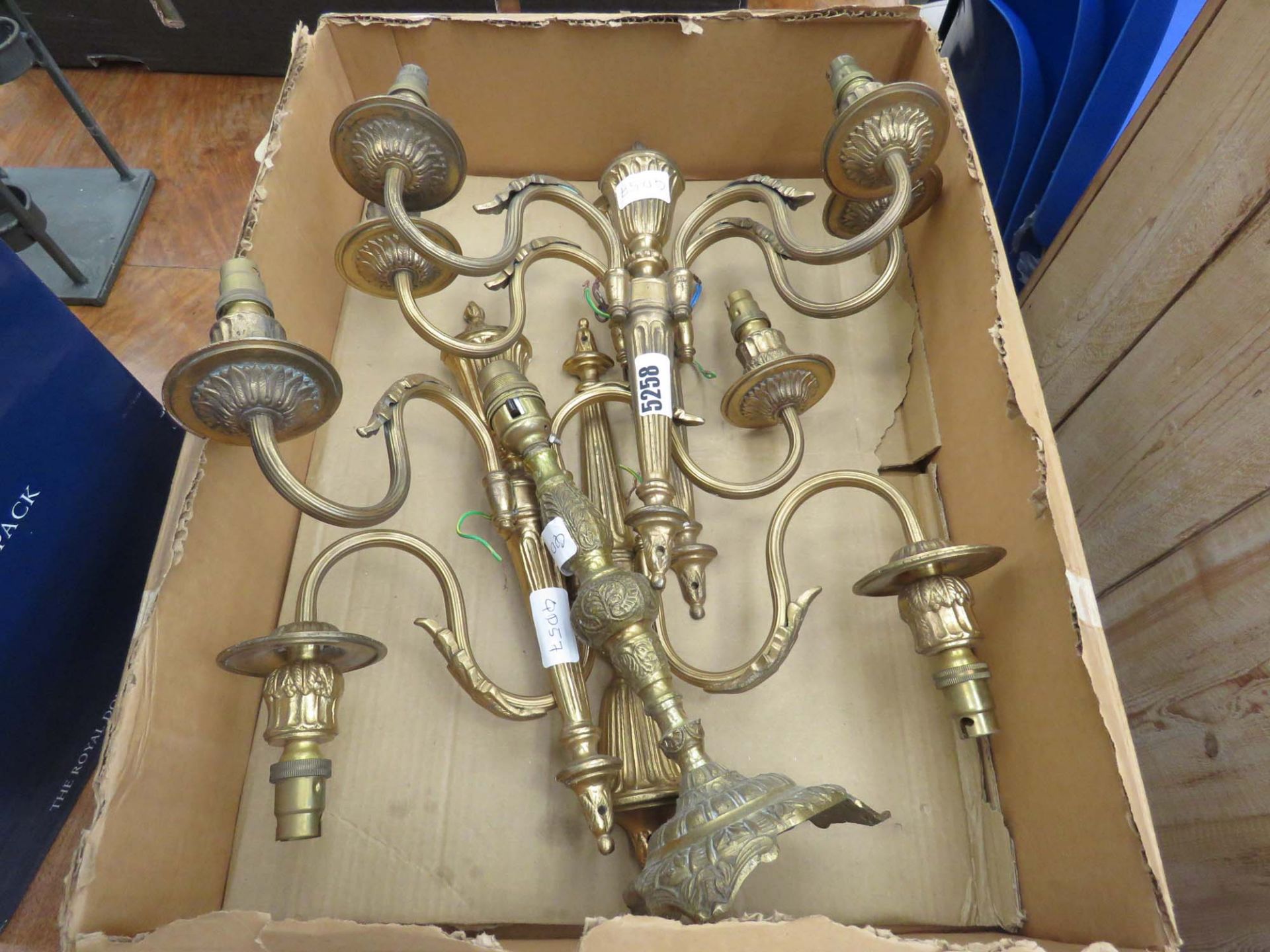 Box containing brass finished two branch wall lights plus a brass table lamp base