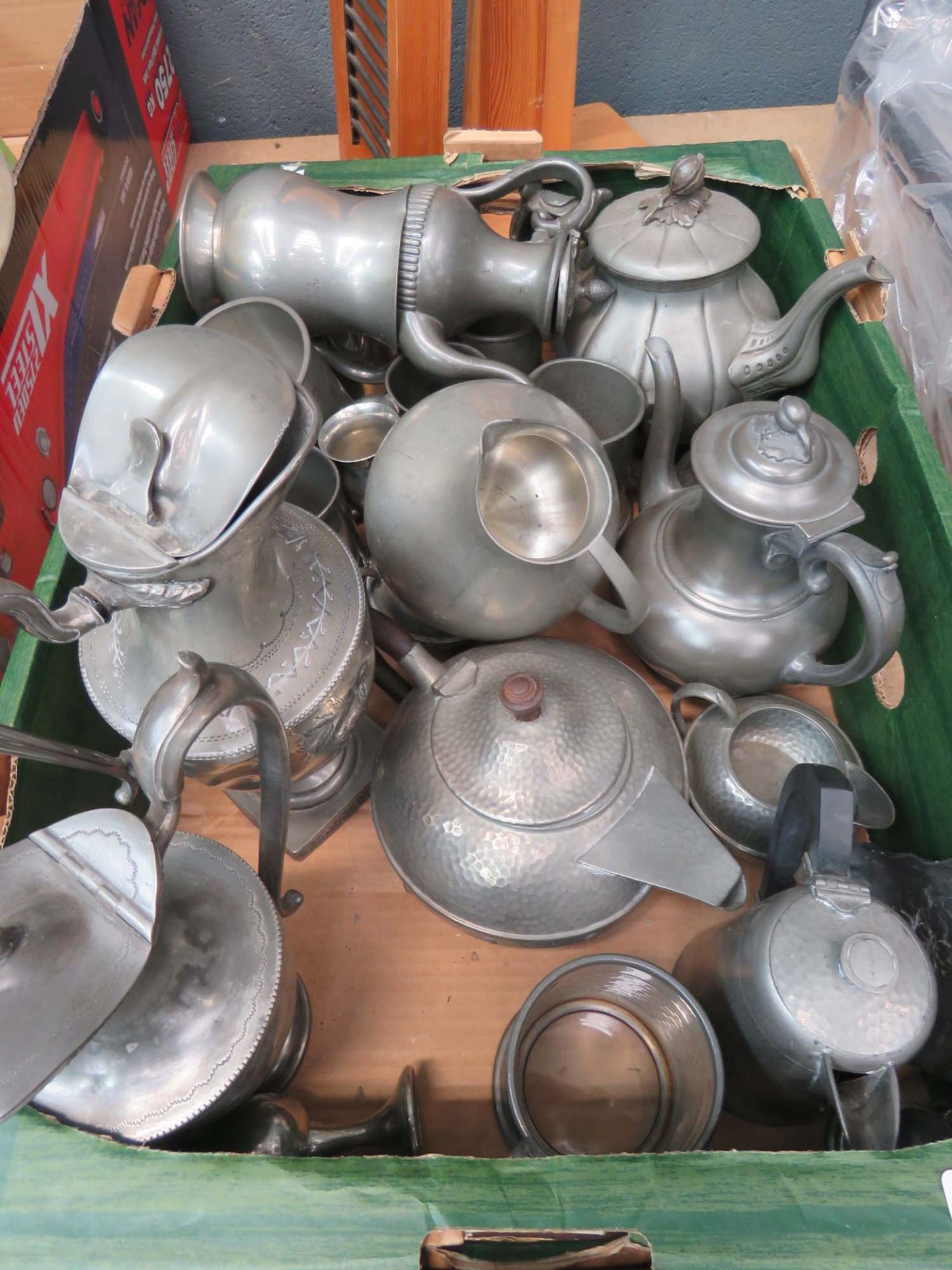 Box containing a quantity of pewter jugs, teapots and ale mugs