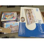 2 boxes containing jigsaw puzzles and a boxed jigboard