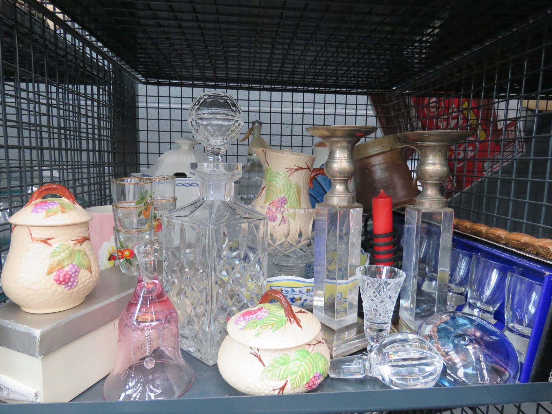 Cage containing shot glasses, decanter, candlesticks, soda siphon and china