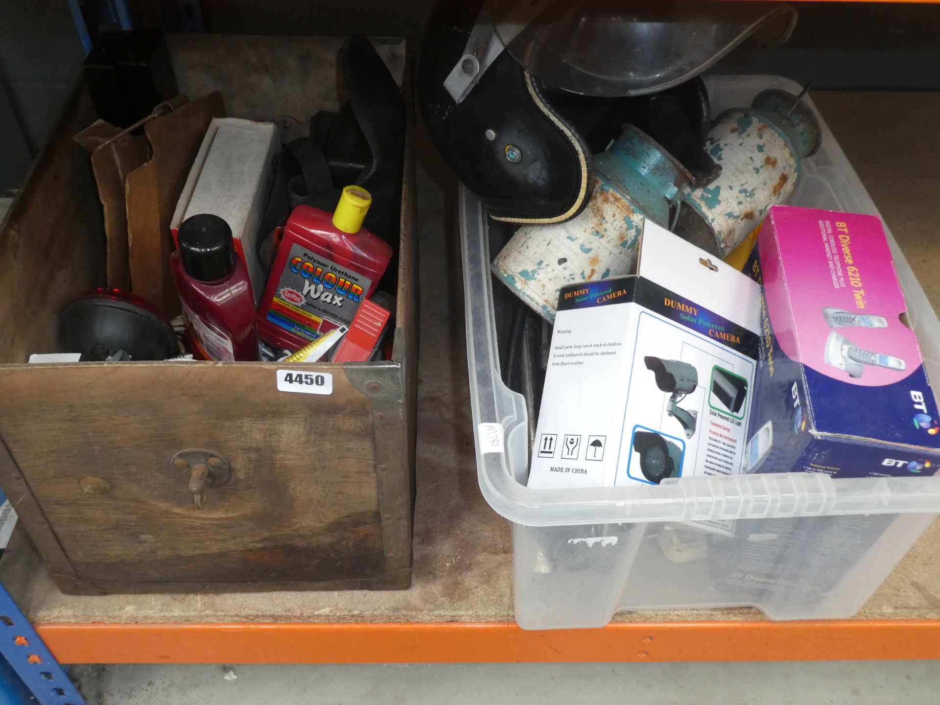 Underbay containing 2 boxes of car polish, lights, vintage motorcycle helmet, phones, dummy security