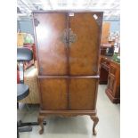 Dark wood cocktail cabinet with two drawers over two