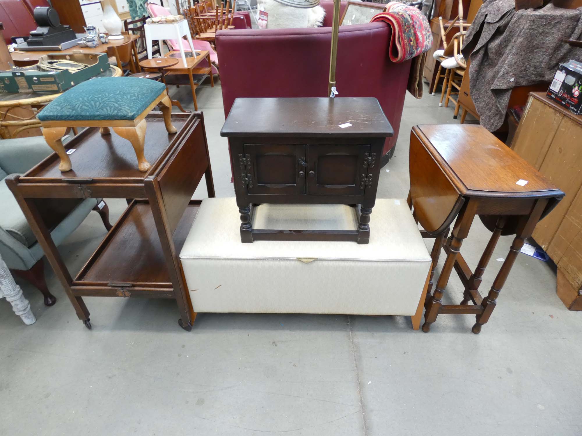 Collection of furniture to include wheeled dark wood trolley, footstool, two door dark wood cabinet,