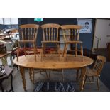 Circular pine kitchen table with 6 spindleback chairs