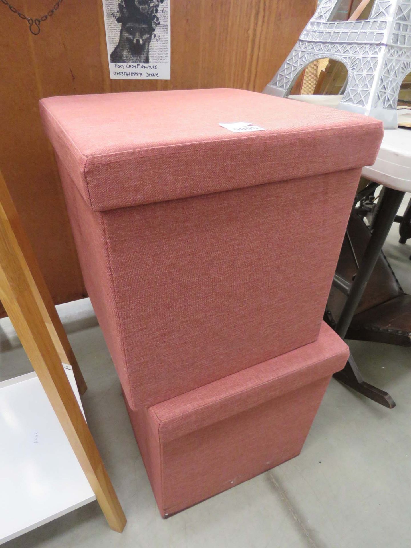 Pair of pink cloth ottomans