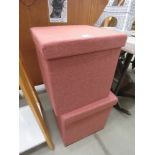 Pair of pink cloth ottomans