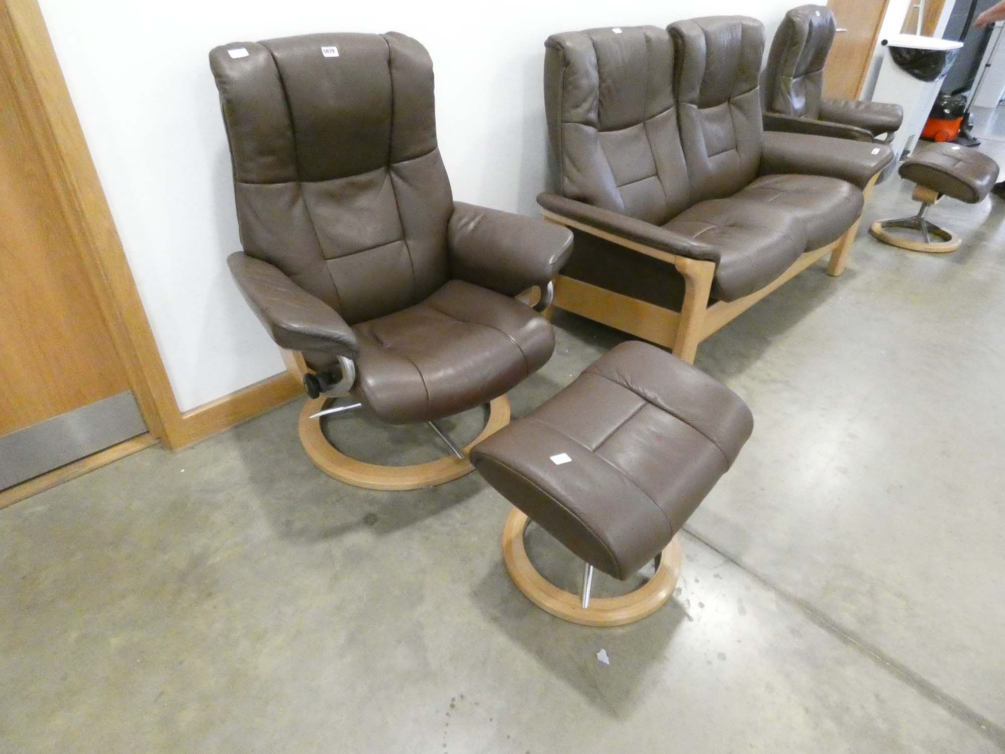 Stressless reclining swivel armchair and matching footstool in brown leather No model, headrest