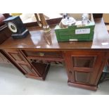 Dark wood kneehole desk of two doors and single drawer