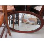 Oval mirror in dark wood frame