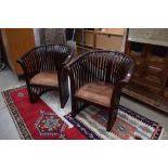 2 darkwood bucket garden chairs in slatted wood form with brown leather seats