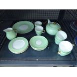 Cage containing a quantity of Wedgwood bone china with green banding to include teacups, teapots and