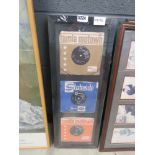 Framed and glazed picture of three singles
