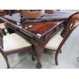 Large dark wood dining table with four matching chairs with gold and fleur de lys fabric