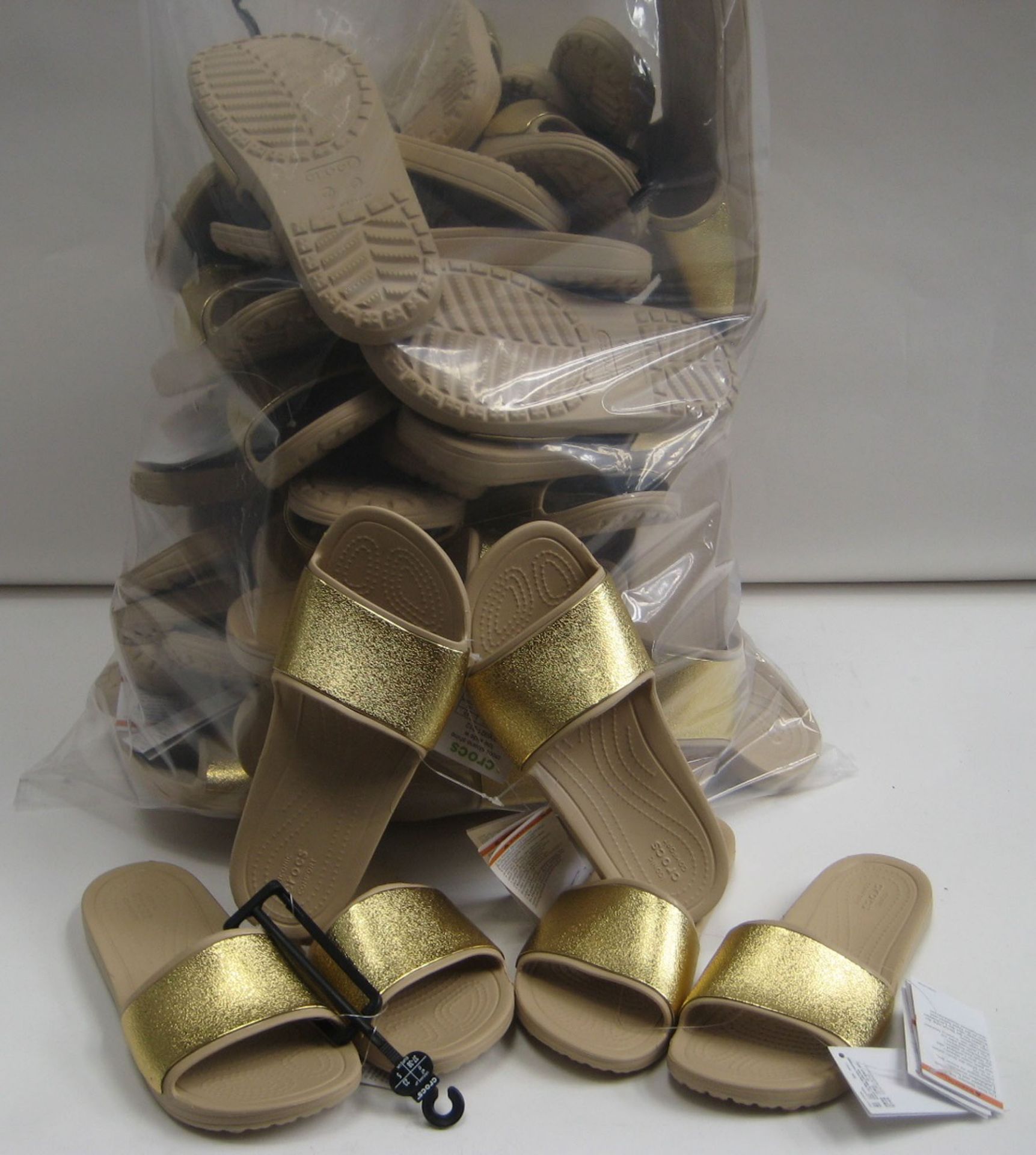 Bag containing approx 24 pairs of Crocs ladies sliders in beige with gold band