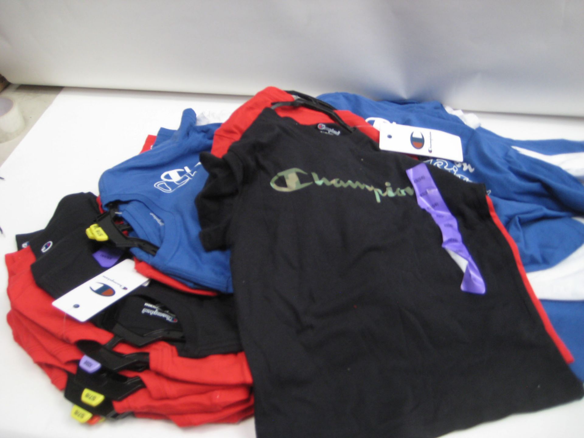 Bag containing approx 15 twin pack sets of children's t shirts by Champion colours to inc. red,