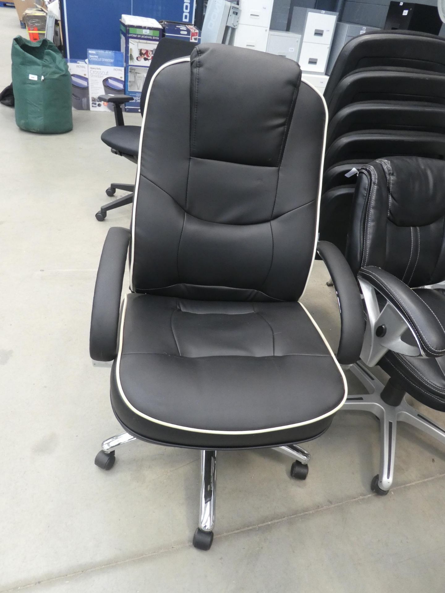 Highback executive swivel armchair in black with cream piping on chrome base