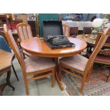 1980's teak extending dining table together with 4 matching chairs