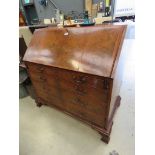 Georgian flame mahogany and feather cross-banded bureau, the fall front over four graduated