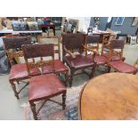 Set of 7 oak ornately carved figural dining chairs with impressed studded leather backs (6+1),
