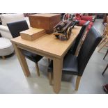 Oak veneer dining table together with 4 leatherette chairs