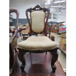 Carved wooden Edwardian chair with upholstered seat and backrest