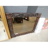 Ornately oak carved wall mirror