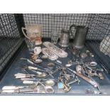Cage containing loose cutlery, pewter mugs, water jug, door handles and touch plates