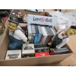 Box containing Laurel & Hardy figures, DVDs and video cassettes