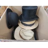 Box containing bowler and sun hats