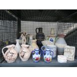 Cage containing a Doulton Lambeth jug, floral decorated vase, ornamental figure, miniature jugs, and