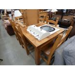 Pine dining table together with a set of 6 matching chairs