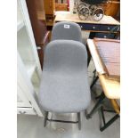 Pair of grey seated bar stools, with black frames