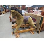 Merrythough rocking horse on pine stand