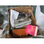 Box containing postcards, fountain pens, paperweight, eyeglass, cigar case, stapler, and stamp