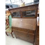 Bureau cabinet with glazed doors over a fall front and 4 drawers