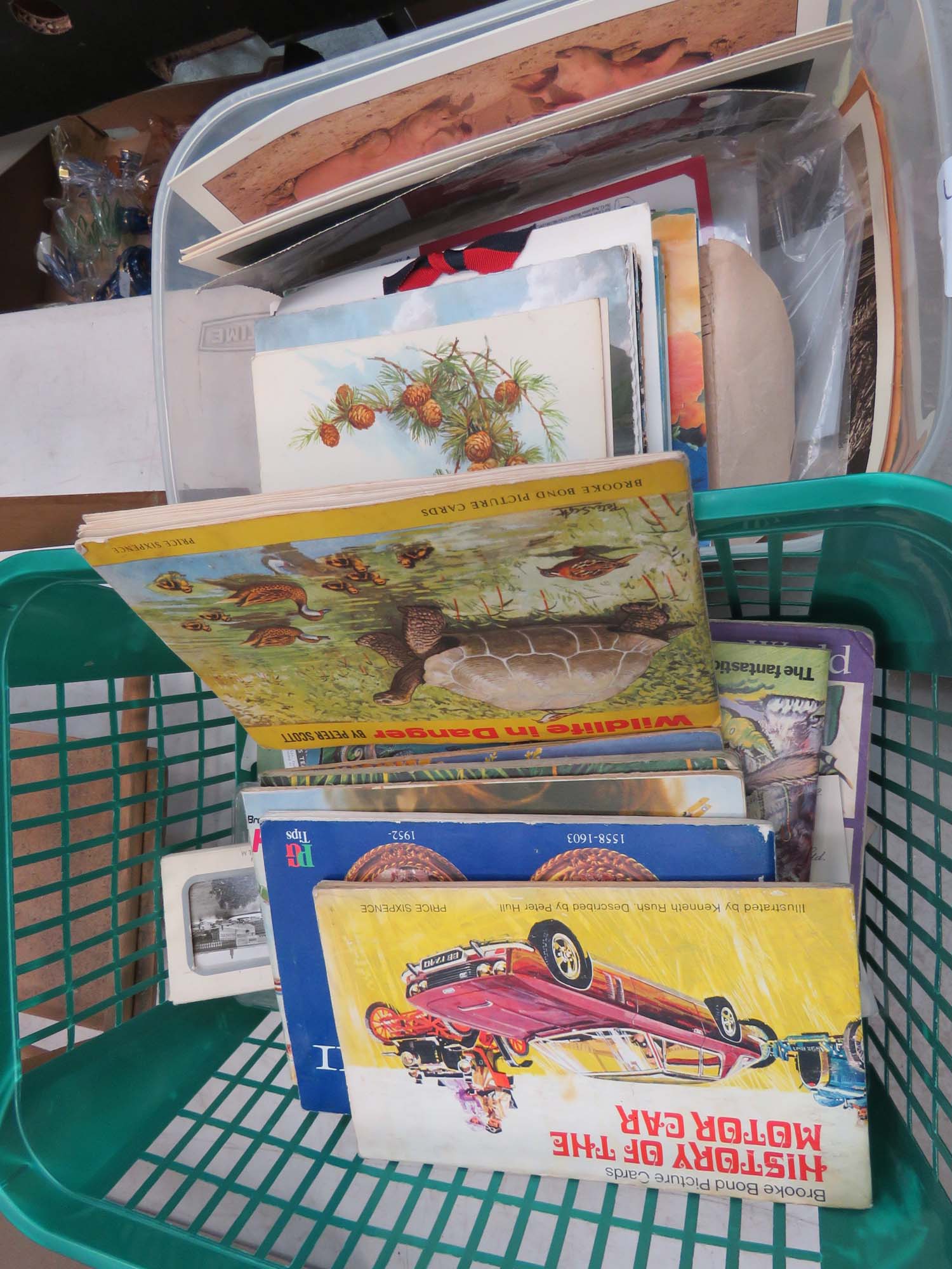 2 boxes containing tea cards and postcards