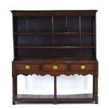 An 18th century oak dresser, the three tier plate rack over three drawers and a gallery,
