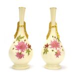 A pair of Royal Worcester China Works ivory blush vases of slender ovoid form decorated with