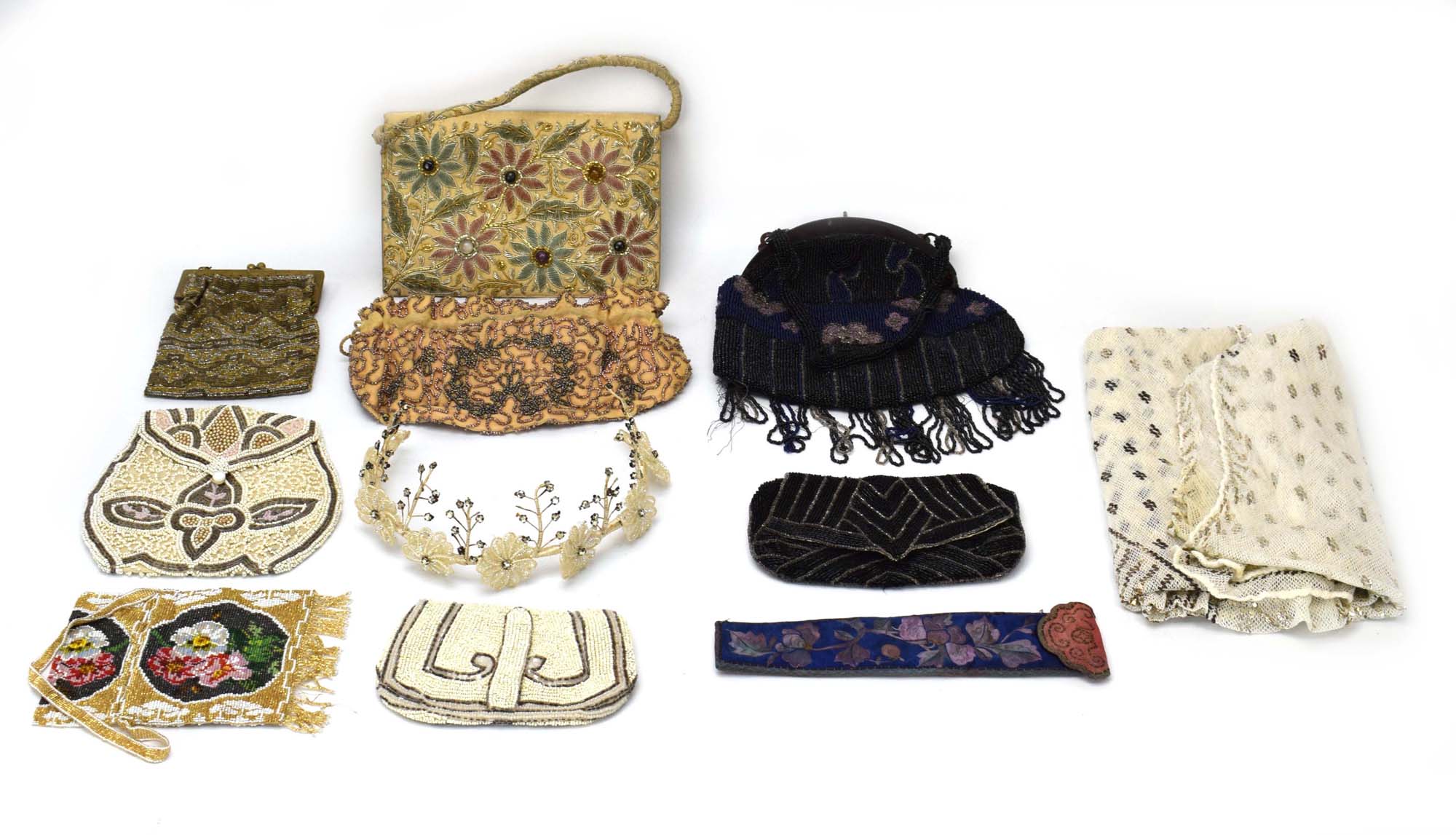 A group of textiles including an embroidered clutch bag with glass roundels,