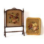A 19th century mahogany fire screen with a bead and stumpwork panel,