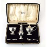 A three piece silver cruet set of vase shaped form, maker BBS Ltd.