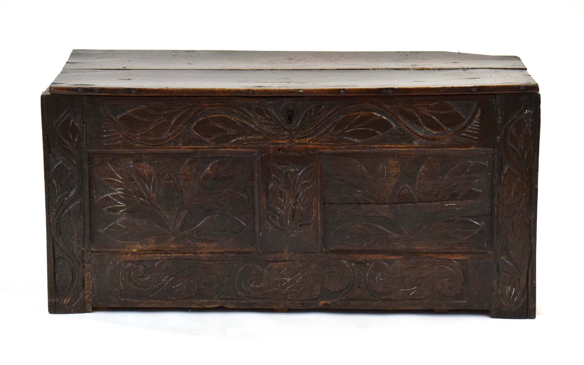 A late 17th/early 18th century oak coffer, the florally carved front with two panels,