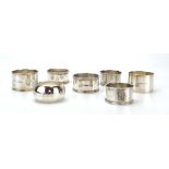 A group of seven early 20th century and later silver napkin rings, various styles, dates and makers,