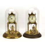 A near pair of early 20th century German anniversary clocks, each with a brass movement,