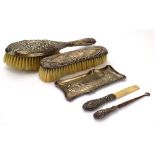 A mixed group of silver mounted dressing table items including two hairbrushes, a button hook,