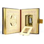 A leather and gilt bound photograph album fitted with a musical box,