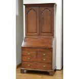 A Georgian mahogany bureau bookcase, the two doors enclosing a stationary cupboard,