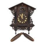 A late 19th/early 20th century wall-mounted cuckoo clock of typical form modelled as a chalet with