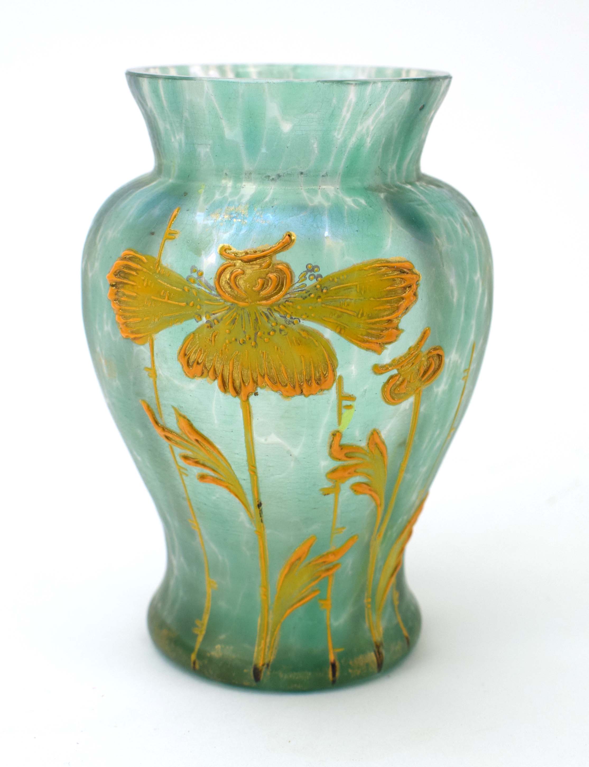 A Loetz type pale green iridescent glass vase of baluster form relief decorated with stylised